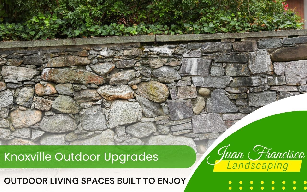 Stone retaining wall improving slope and structure in yard